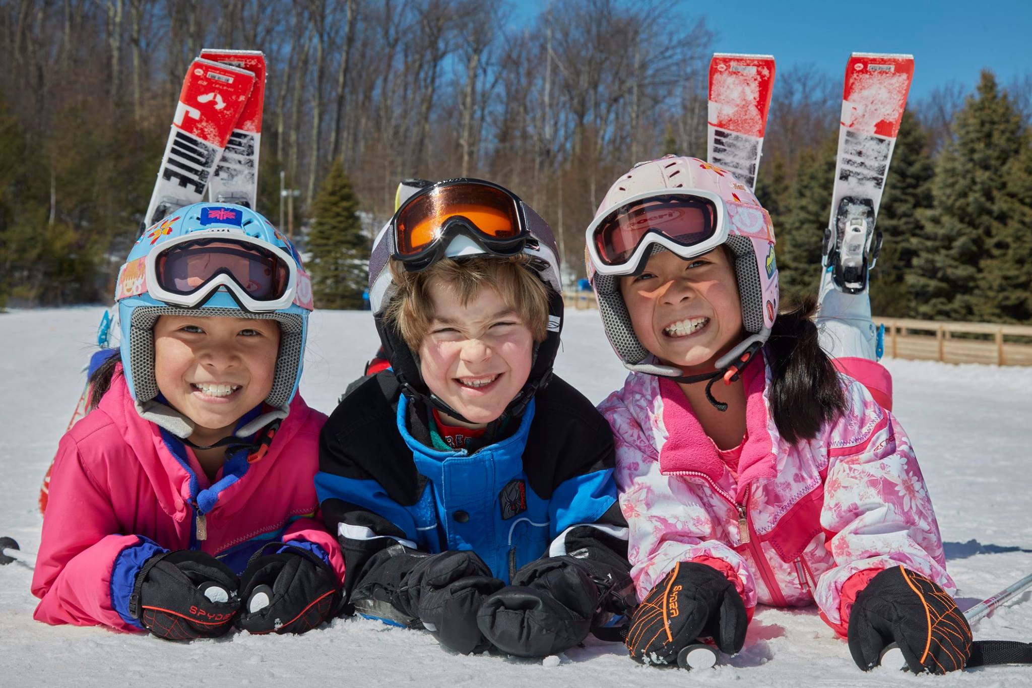 Kids smiling in skis